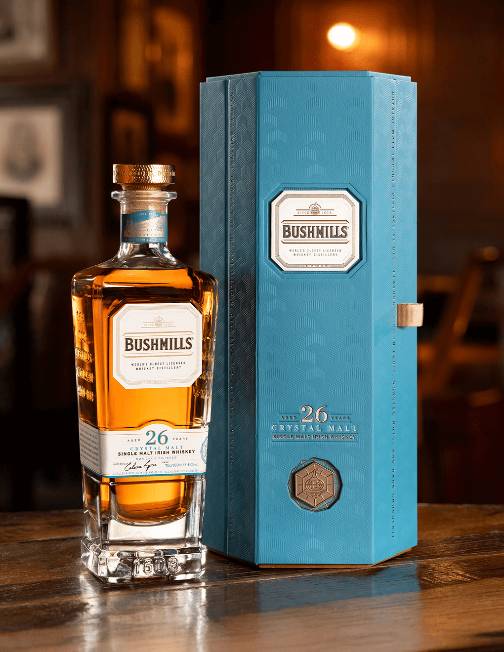 Bushmills 26 Year with it's gift box on a table.