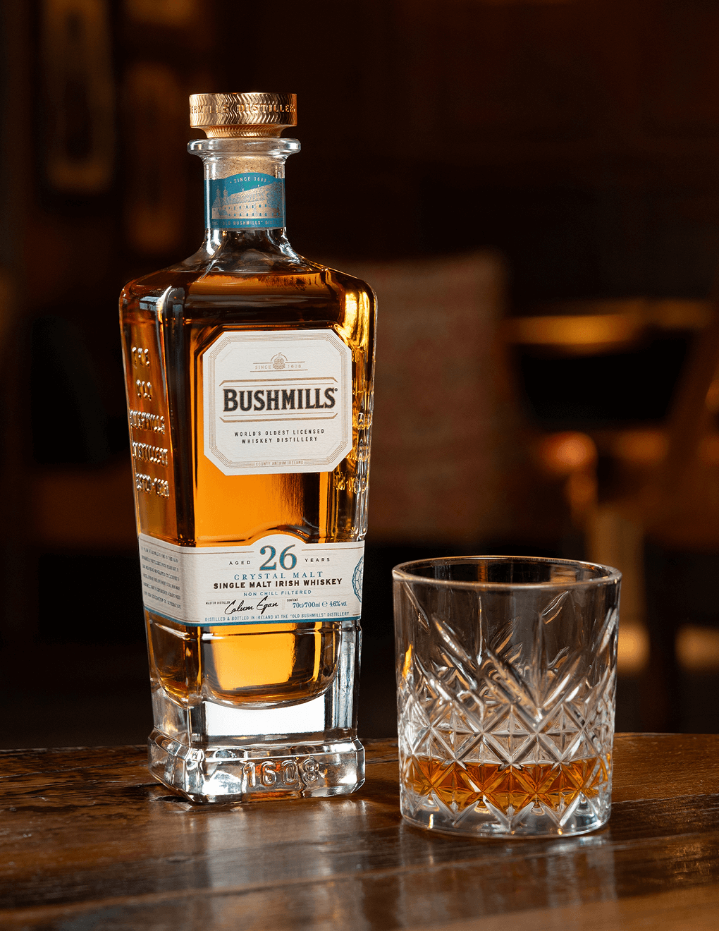 Bushmills 26 Year with neat pour on a table.
