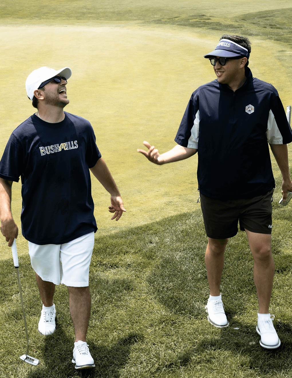 Two men wearing Bushmills x Malbon apparel and hats.