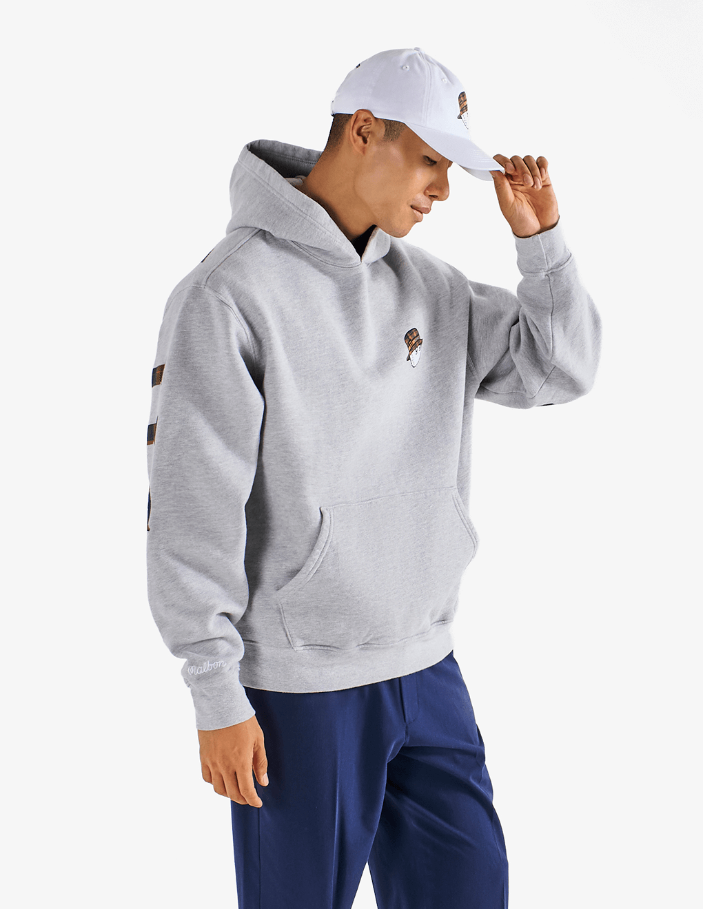 Man modeling Bushmills x Malbon white hat side view.