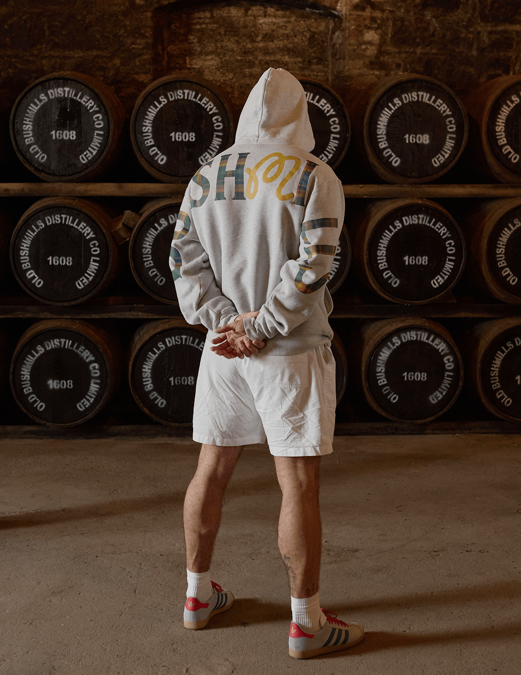 Back of Bushmills x Malbon hoodie in Bushmills distillery.