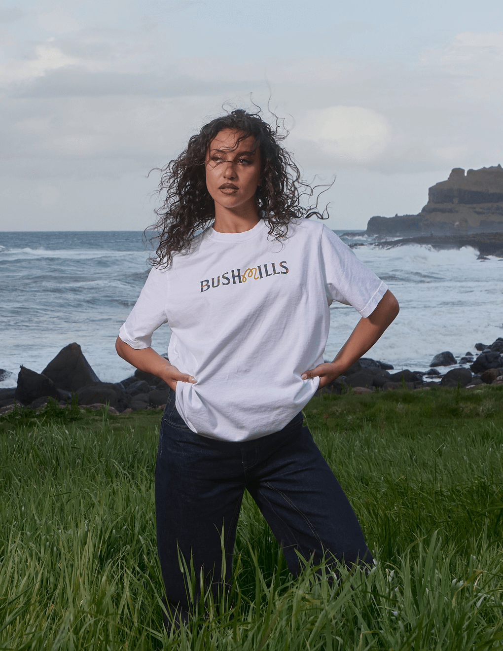 Front of Bushmills x Malbon white tee on model on a cliff by Irish seas.