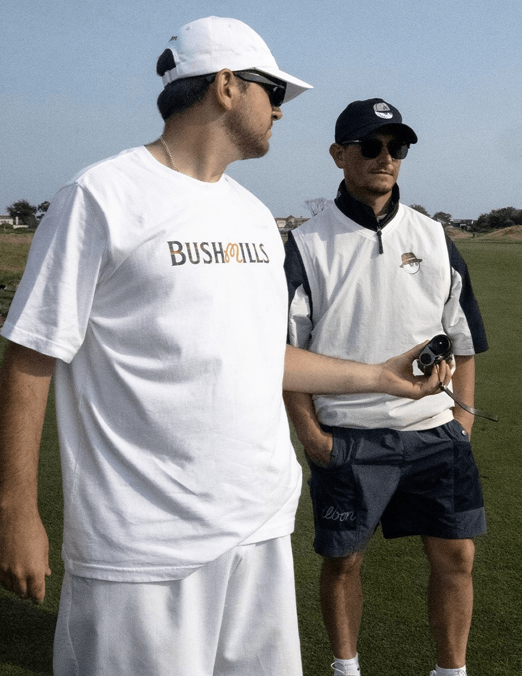 Two golfers wearing Bushmills x Malbon collection apparel.