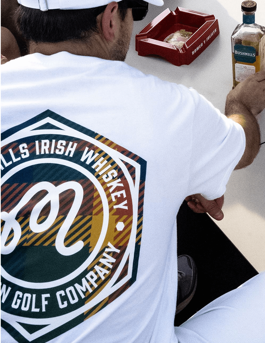 Detail shot of emblem on back of white Bushmills x Malbon collab tee.