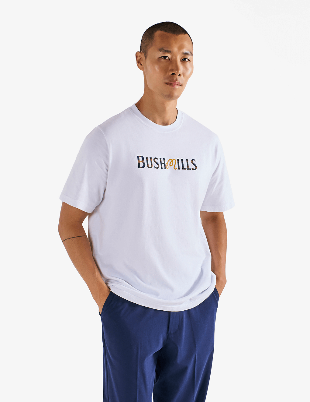 Model wearing of Bushmills x Malbon white t-shirt, showing front of shirt.