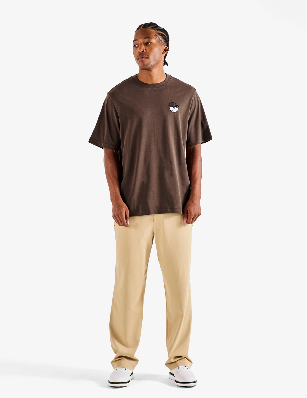 Front of the brown Bushmills X Malbon Tee on a model with khaki pants.