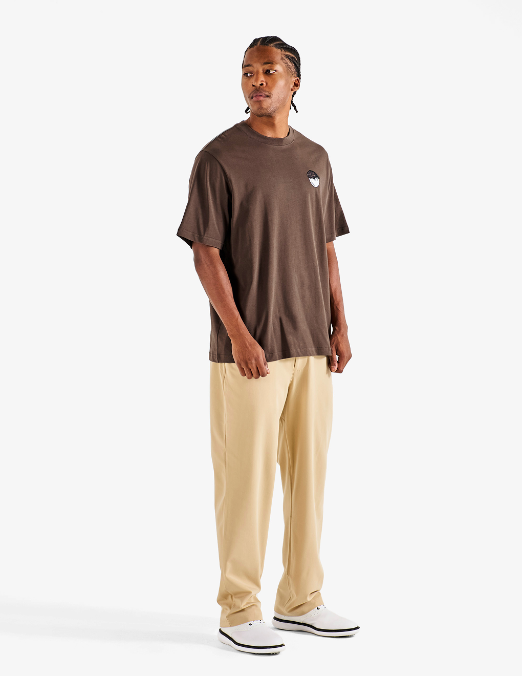 Side of the brown Bushmills X Malbon Tee on a model with khaki pants.