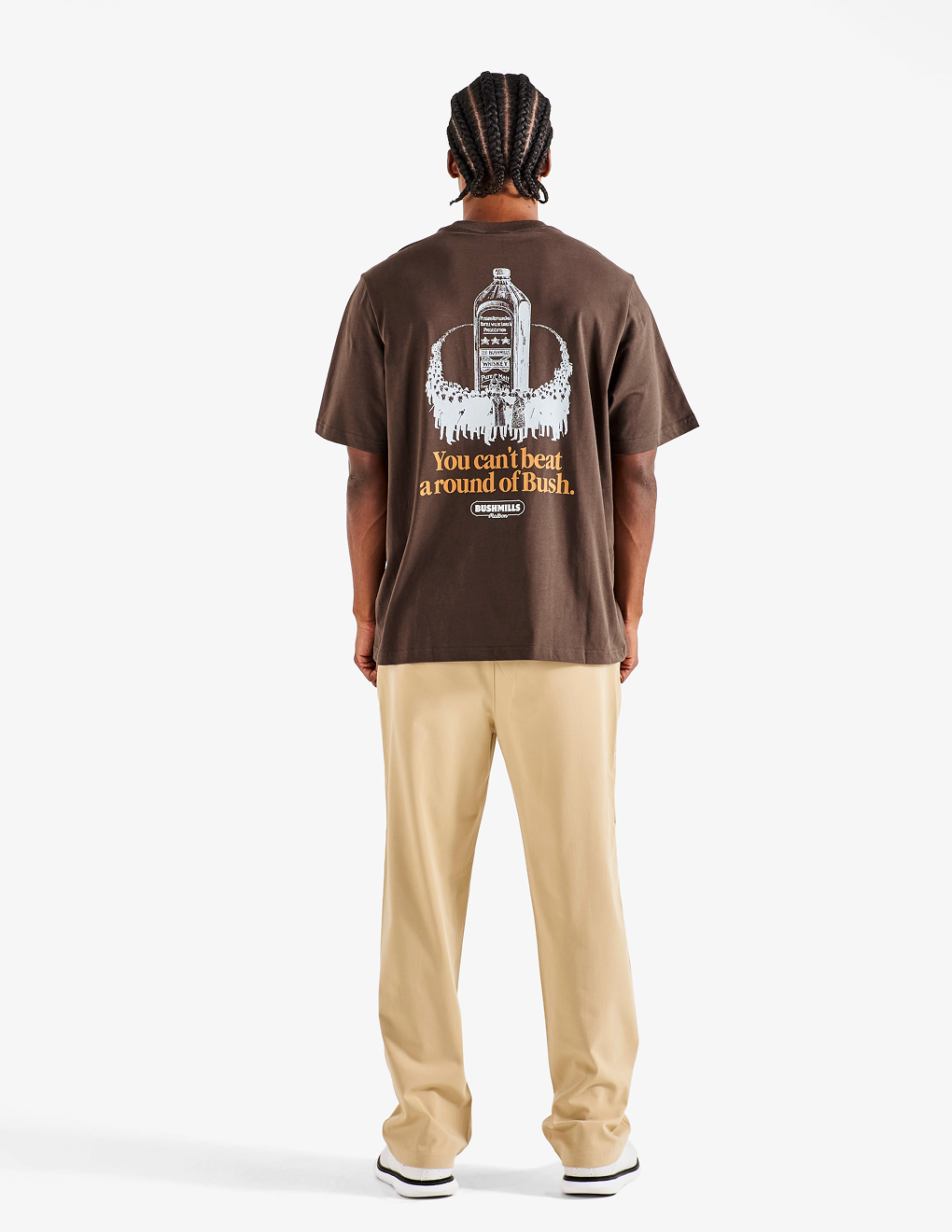 Back of the brown Bushmills X Malbon Tee on a model with khaki pants.