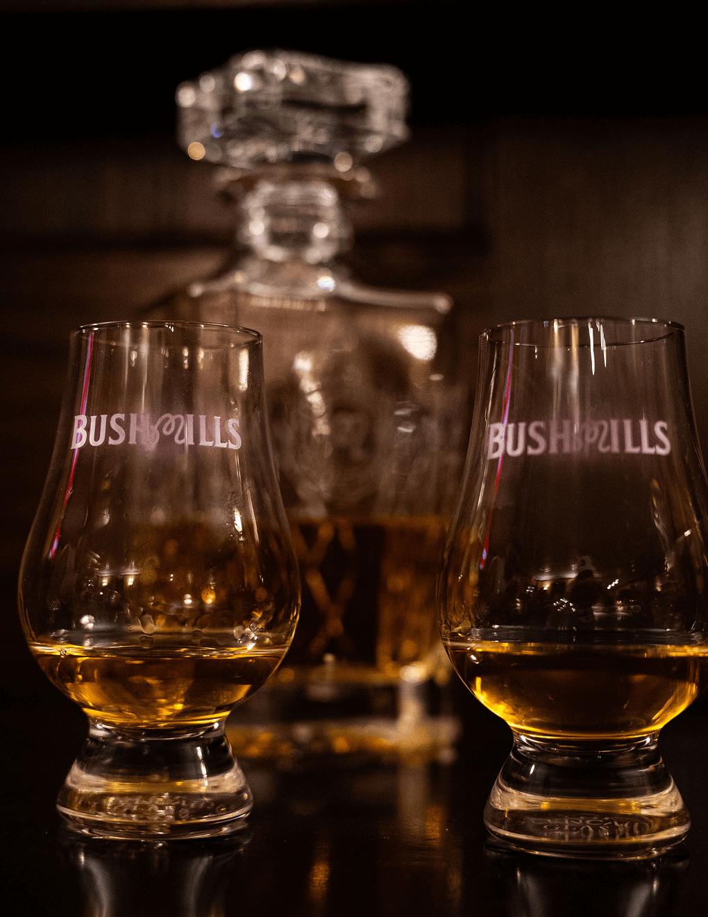 Bushmills x Malbon etched decanter with Bushmills x Malbon Glencairn glasses.