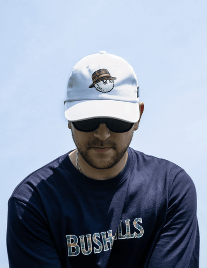 Man wearing Bushmills x Malbon white hat on golf course.