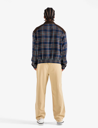 Back view of Bushmills X Malbon Wool & Leather Jacket on a model with khaki pants.